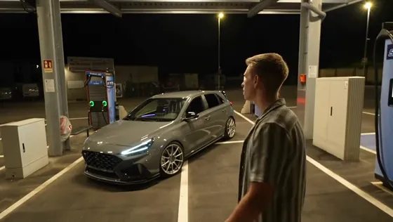 The performer turns toward the car.